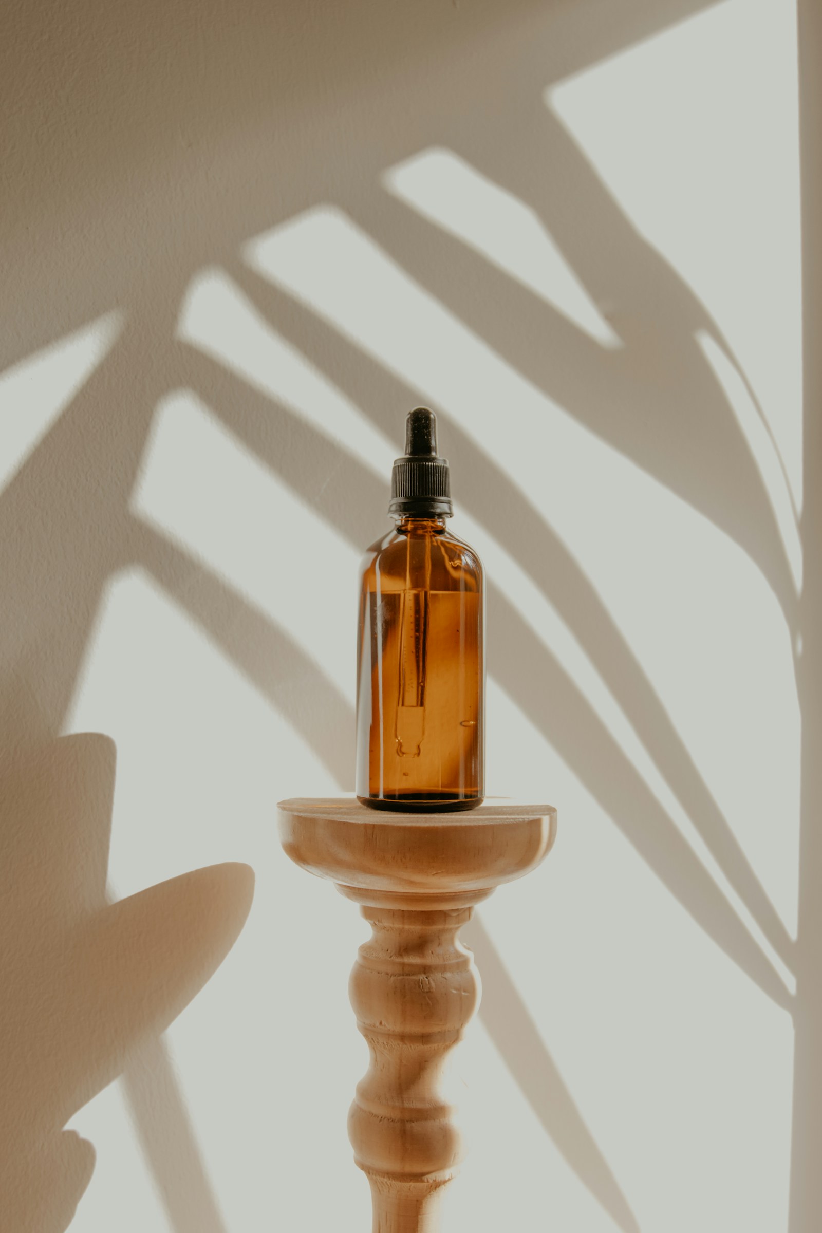 Skincare bottles arranged with carefully lit shadows